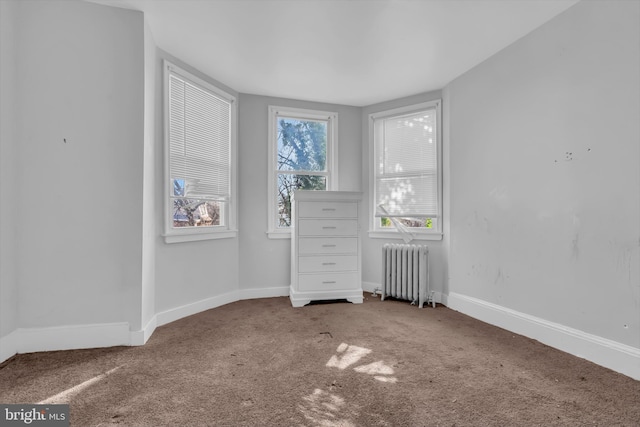 unfurnished bedroom with carpet and radiator heating unit