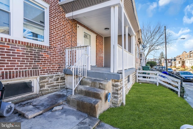 view of exterior entry featuring a porch