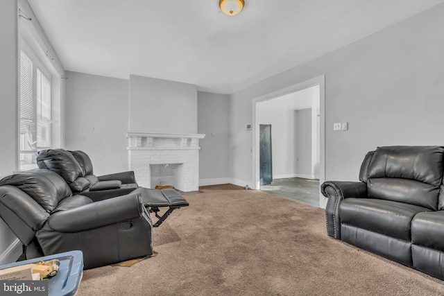 living room with carpet floors and a brick fireplace