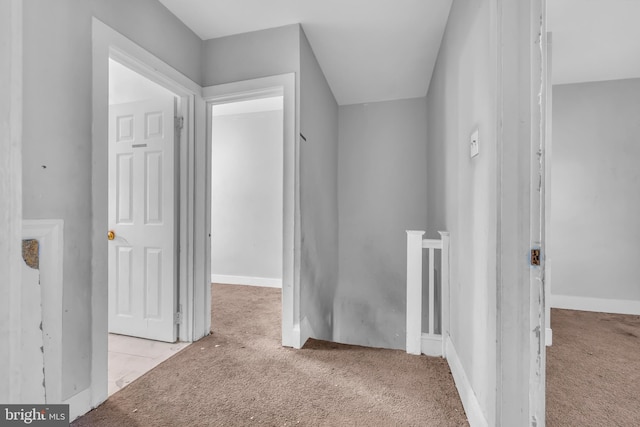 hallway with light colored carpet