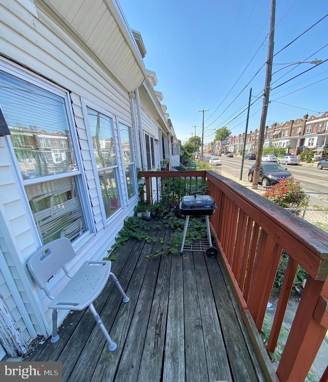 wooden deck with a grill