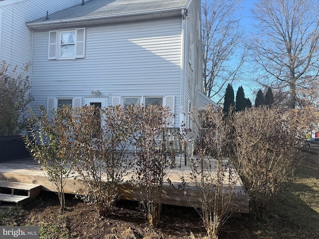 view of property exterior with a deck