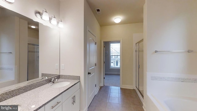 bathroom featuring tile patterned flooring, vanity, and independent shower and bath