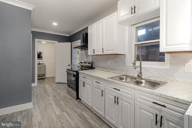 kitchen featuring sink, wall chimney exhaust hood, stainless steel electric stove, white cabinets, and light wood-type flooring