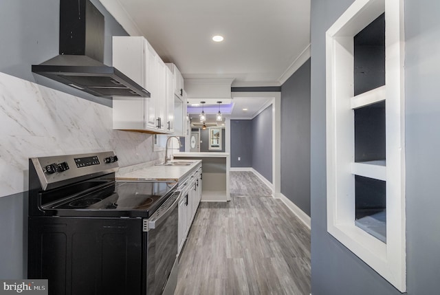 kitchen with white cabinets, sink, wall chimney exhaust hood, and stainless steel electric range