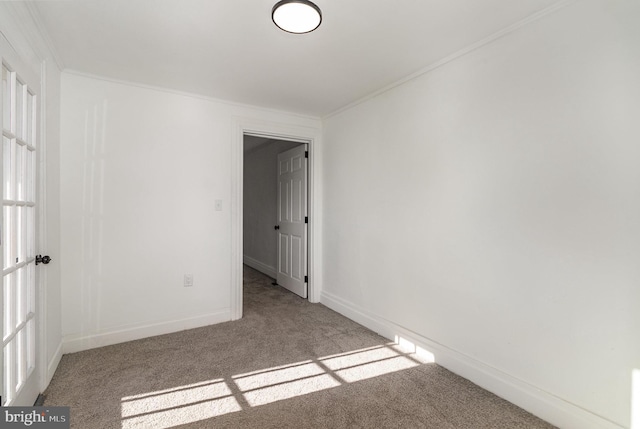 spare room with light carpet and crown molding