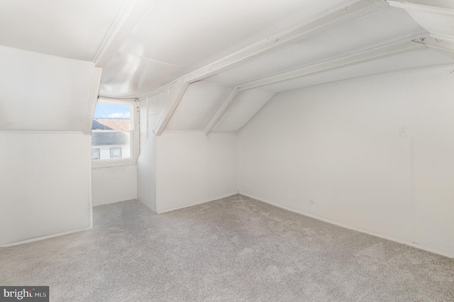 bonus room featuring light colored carpet and lofted ceiling