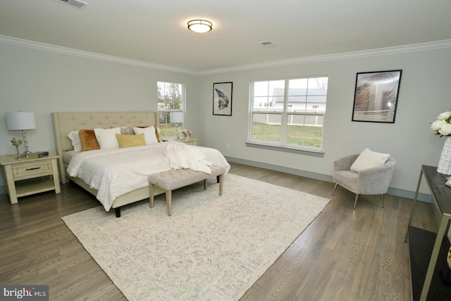 bedroom featuring crown molding and dark wood-type flooring