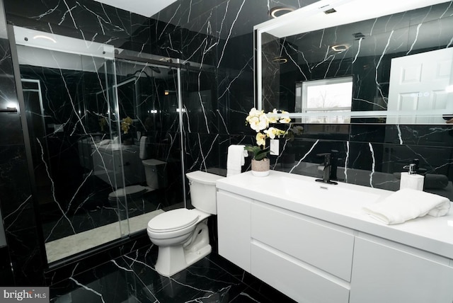 bathroom featuring decorative backsplash, vanity, tile walls, toilet, and a shower with shower door