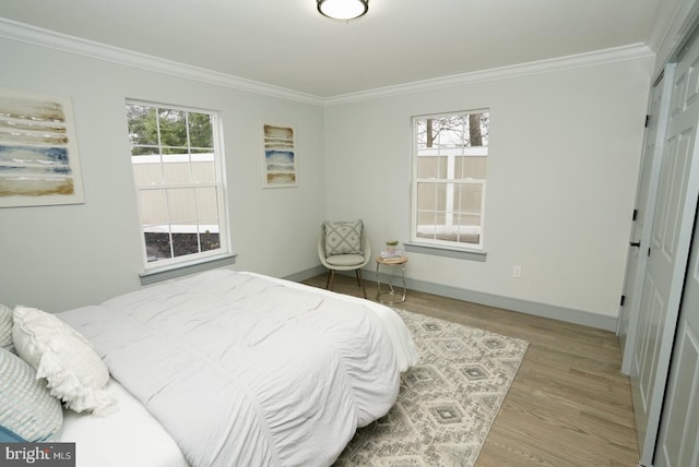 bedroom featuring light wood-type flooring and ornamental molding