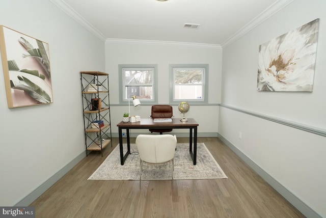 office space featuring ornamental molding, lofted ceiling, and light wood-type flooring