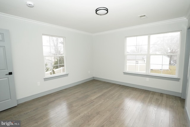 unfurnished room with ornamental molding and light hardwood / wood-style flooring