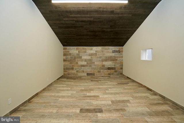 hall featuring light wood-type flooring and lofted ceiling