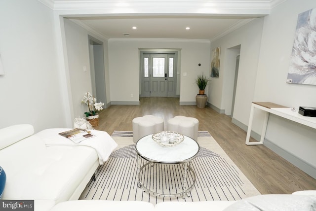 living room featuring light hardwood / wood-style floors and crown molding