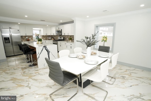 dining space with crown molding