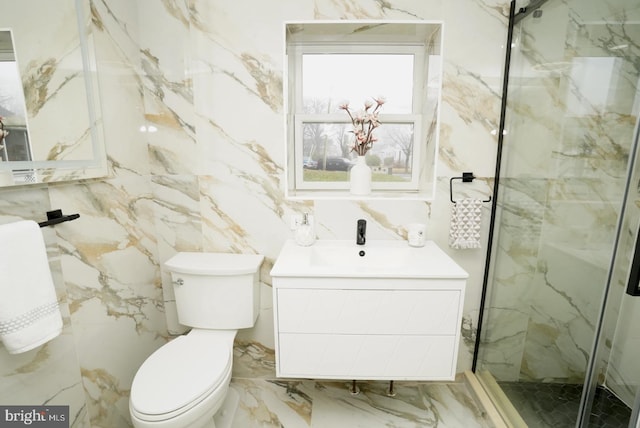 bathroom with vanity, toilet, a shower with door, and tile walls