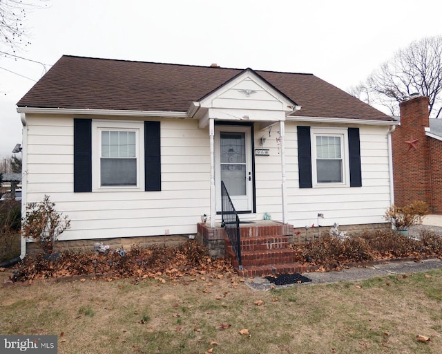 bungalow-style house with a front yard