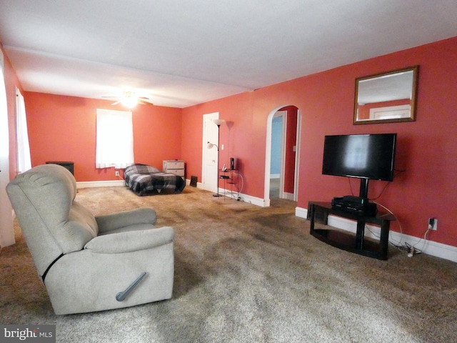 living room with ceiling fan and carpet floors