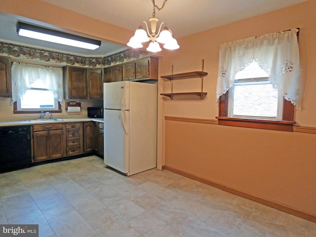 kitchen with white refrigerator, sink, black dishwasher, decorative light fixtures, and a chandelier