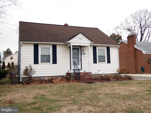 bungalow-style home featuring a front yard