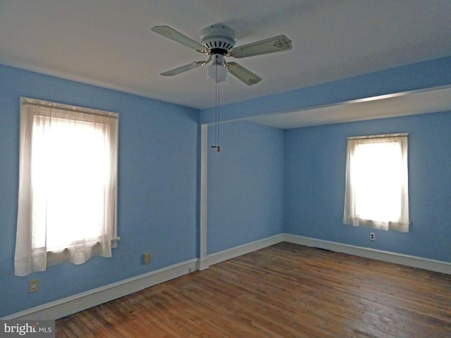 unfurnished room featuring dark hardwood / wood-style floors and ceiling fan