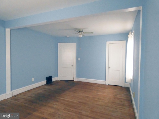 spare room with ceiling fan and dark wood-type flooring