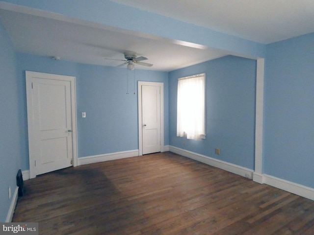 spare room with ceiling fan and dark hardwood / wood-style flooring