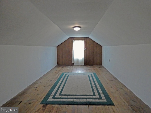 bonus room featuring vaulted ceiling and light wood-type flooring