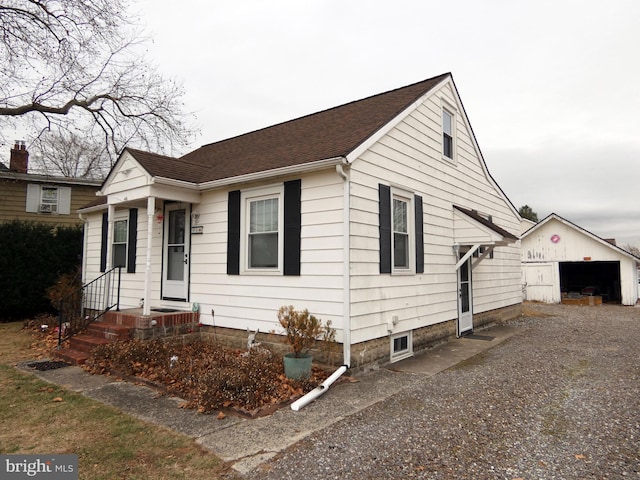 view of front of property featuring an outdoor structure and a garage