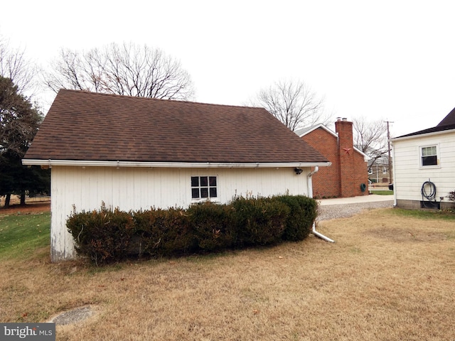 view of side of home featuring a yard