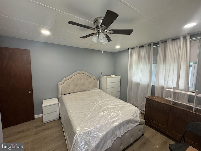 bedroom with ceiling fan and wood-type flooring