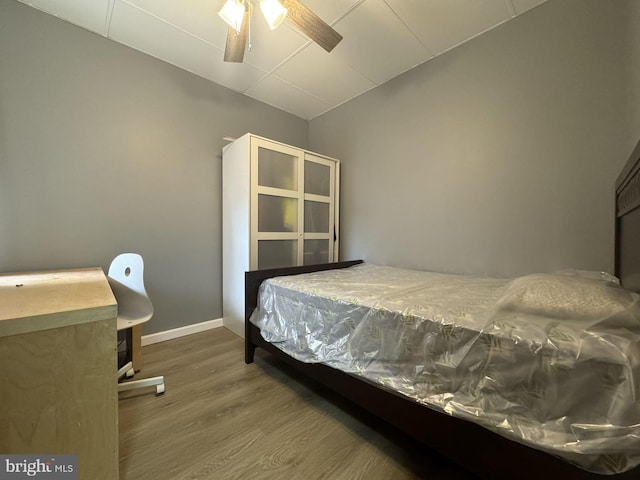 bedroom featuring ceiling fan, vaulted ceiling, and hardwood / wood-style flooring