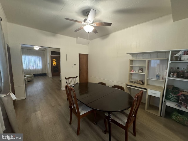 dining space with dark hardwood / wood-style flooring and ceiling fan