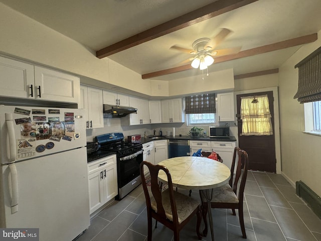 kitchen with white cabinets, beam ceiling, stainless steel appliances, and a wealth of natural light