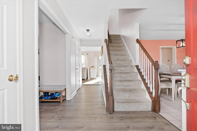 stairway with hardwood / wood-style flooring