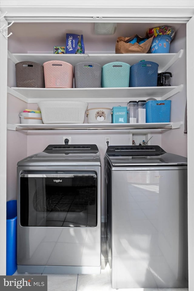 laundry area featuring tile patterned floors and separate washer and dryer