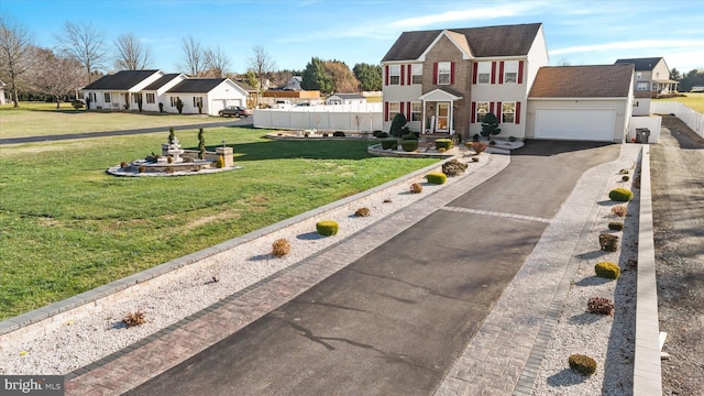 view of front of home with a garage and a front lawn