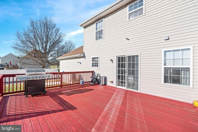 wooden deck with a grill