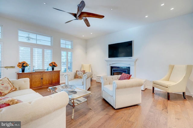 living room featuring ceiling fan and light wood-type flooring