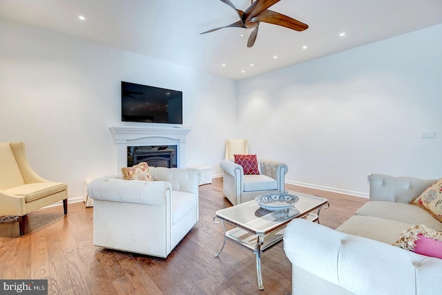 living room featuring hardwood / wood-style flooring and ceiling fan