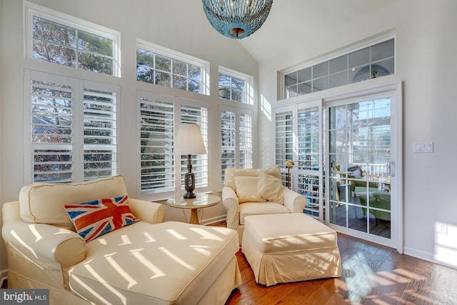 sunroom / solarium featuring lofted ceiling and a healthy amount of sunlight