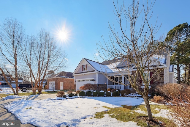 view of property with a garage and a porch