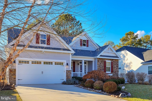 view of front of home featuring a porch and a garage