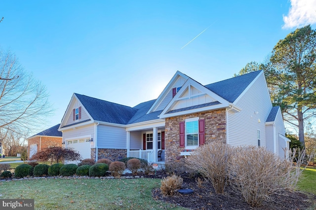 view of front facade with a garage, a porch, and a front lawn