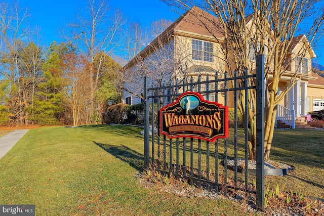 community sign featuring a yard