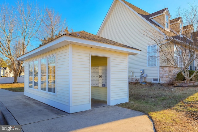 view of side of home featuring mail boxes