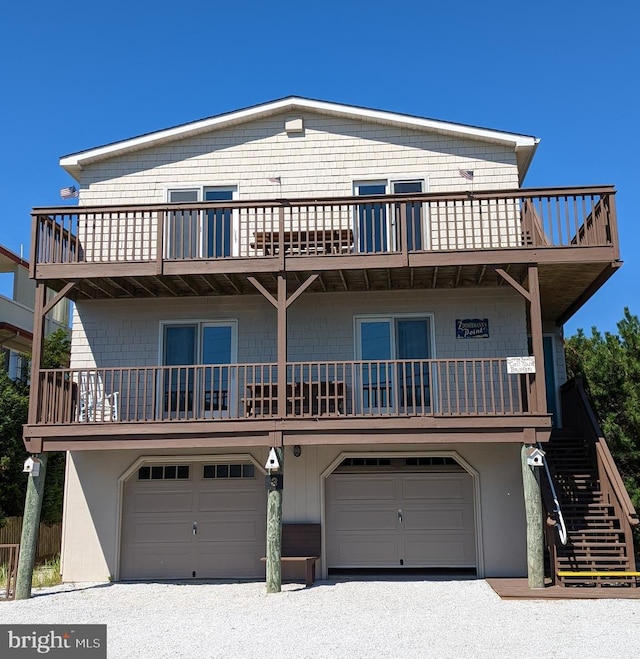 view of front of home featuring a garage and a balcony