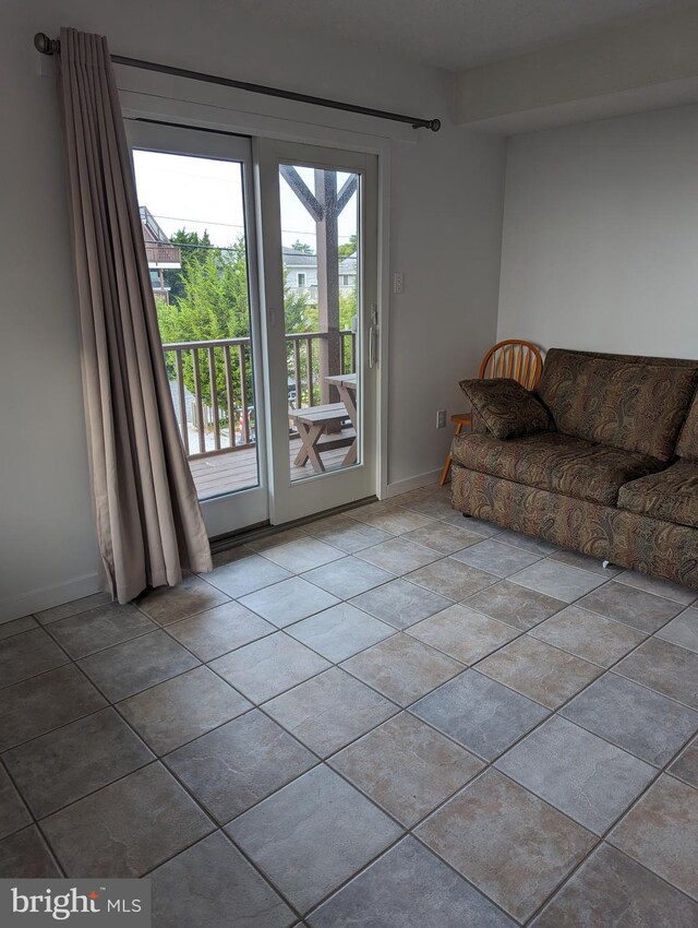 unfurnished living room featuring light tile patterned floors