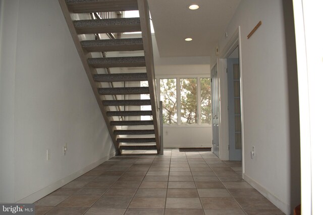 hallway with tile patterned flooring