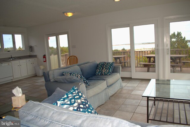 living room featuring light tile patterned flooring and sink